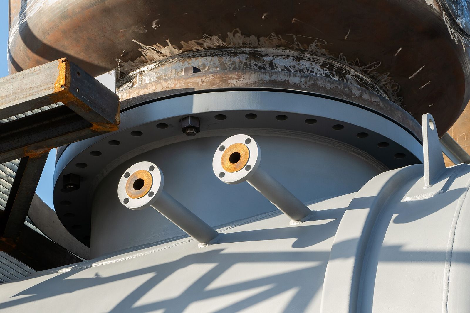 Nozzle couplings welded to a pressure vessel shell under construction