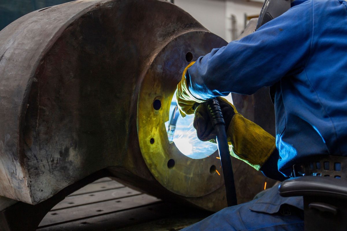Welder working inside a heavy flanged part